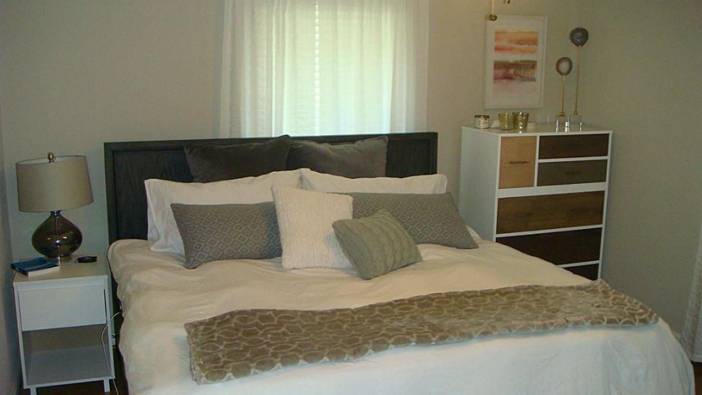 112 Robert Lee Road Houston, TX 77009 - Photo 8 of 14 a large bed sitting in a bedroom next to a window
