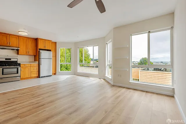 a view of a kitchen with a sink and a refrigerator