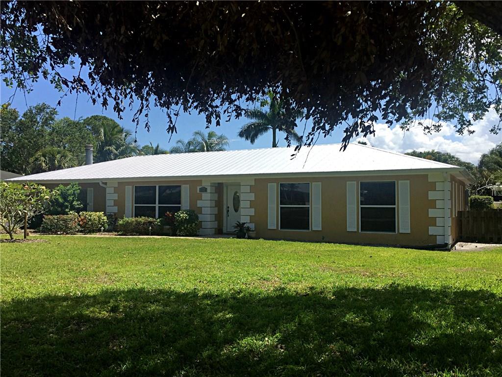 1674 Northwest Spruce Ridge Drive Stuart, FL 34994 - Photo 1 of 9 a view of a house with a garden