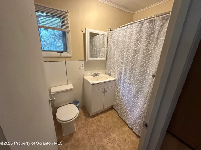 a spacious bedroom with a bed and a window