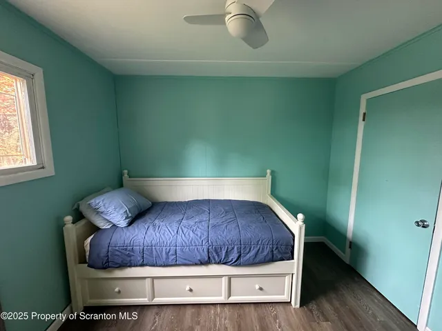 a bedroom with a bed and a window