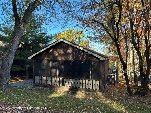 a backyard of a house with bicycles parked and swing