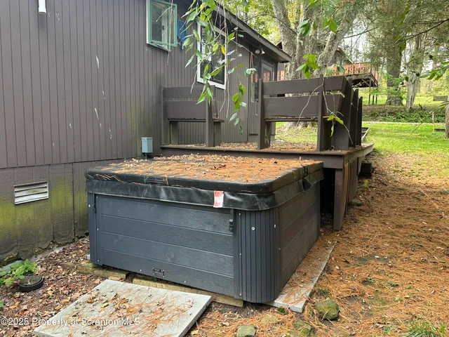 a kitchen with stainless steel appliances granite countertop a sink a stove a refrigerator a kitchen island with wooden cabinets and floor