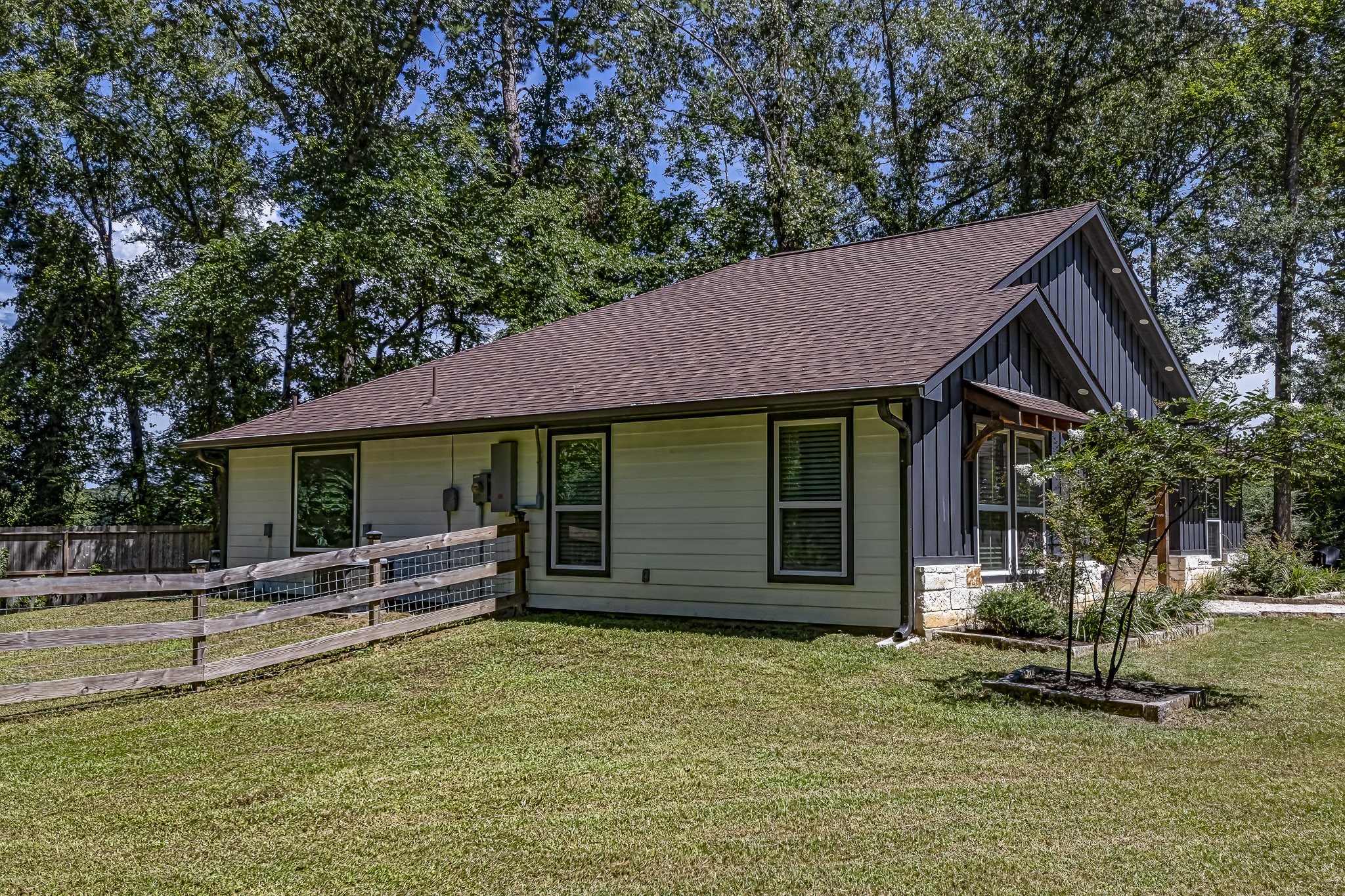 40 Bob Steele Road Coldspring, TX 77331 - Photo 41 of 50 a view of a house with a yard potted plants and a large tree