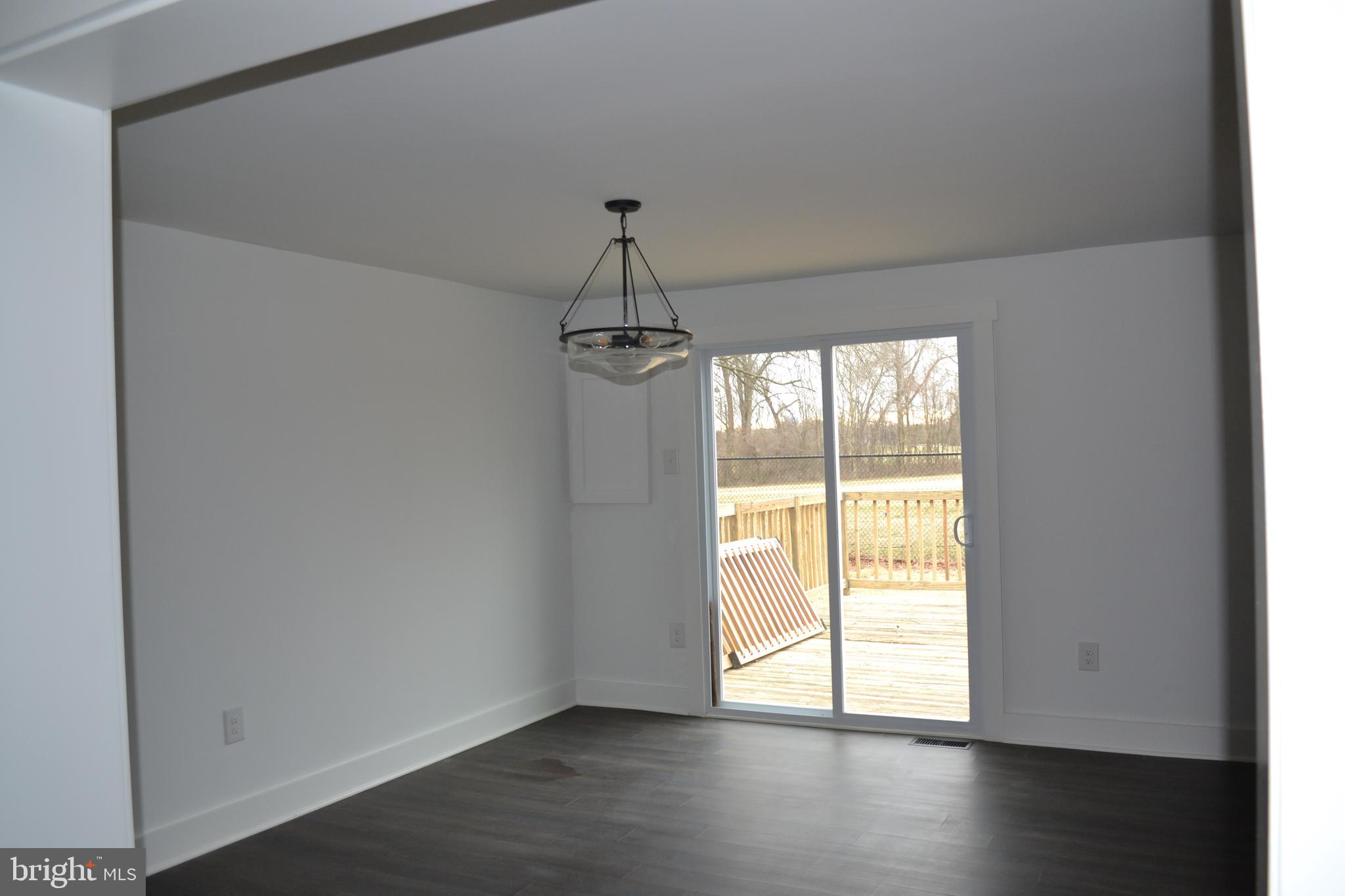 125 Cove Point Road Lusby, MD 20657 - Photo 15 of 32 Wide opening into dining room from the living room
