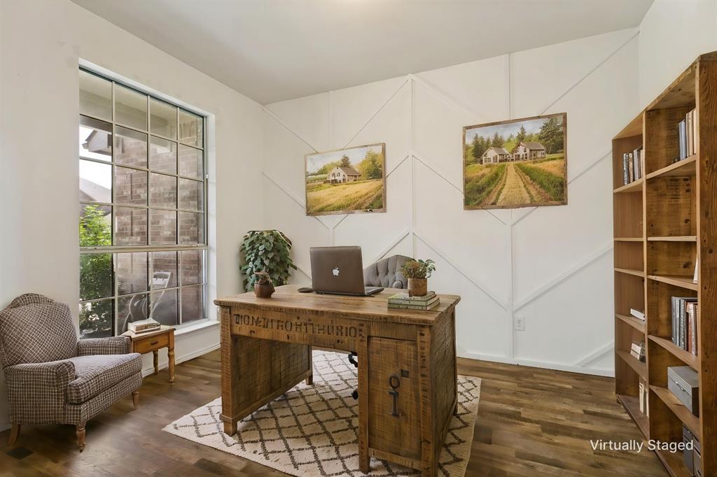 4107 Waverly Road Corinth, TX 76208 - Photo 4 of 30 The private office downstairs features double French doors and a unique accent wall which makes the perfect backdrop for special things. The window overlooks the covered front porch and this room features fresh, neutral paint, and LVP flooring.