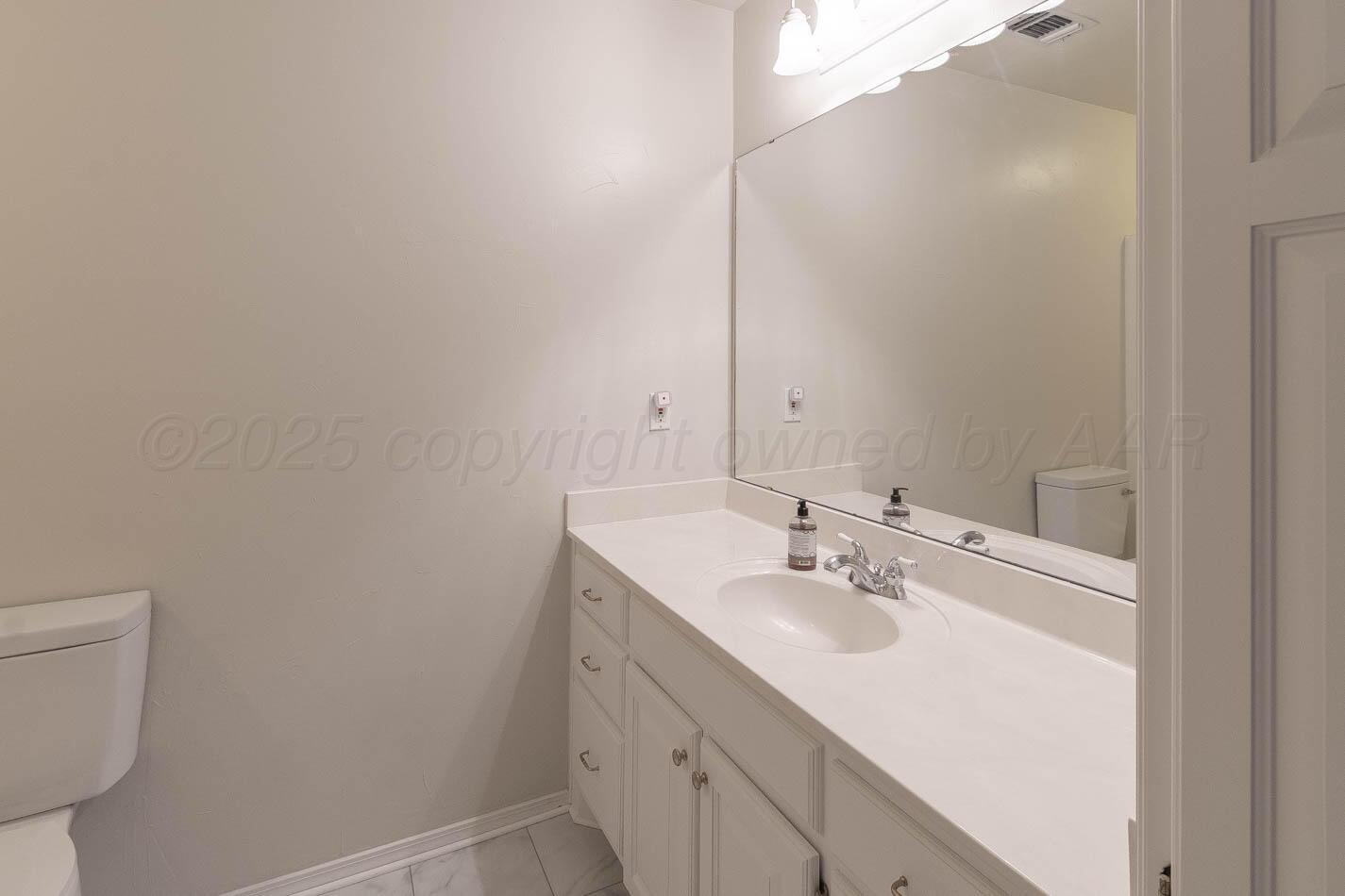6364 Suncrest Way Amarillo, TX 79124 - Photo 15 of 18 a bathroom with a sink toilet and vanity