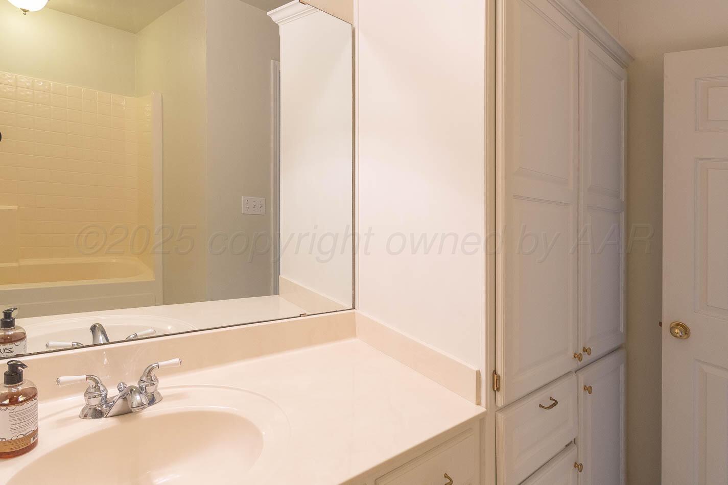 6364 Suncrest Way Amarillo, TX 79124 - Photo 17 of 18 a bathroom with a sink and a mirror