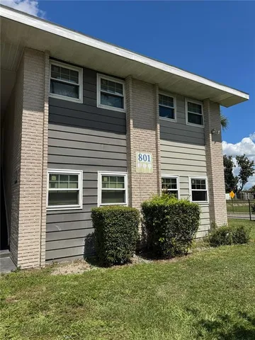a view of a house with a yard and plants