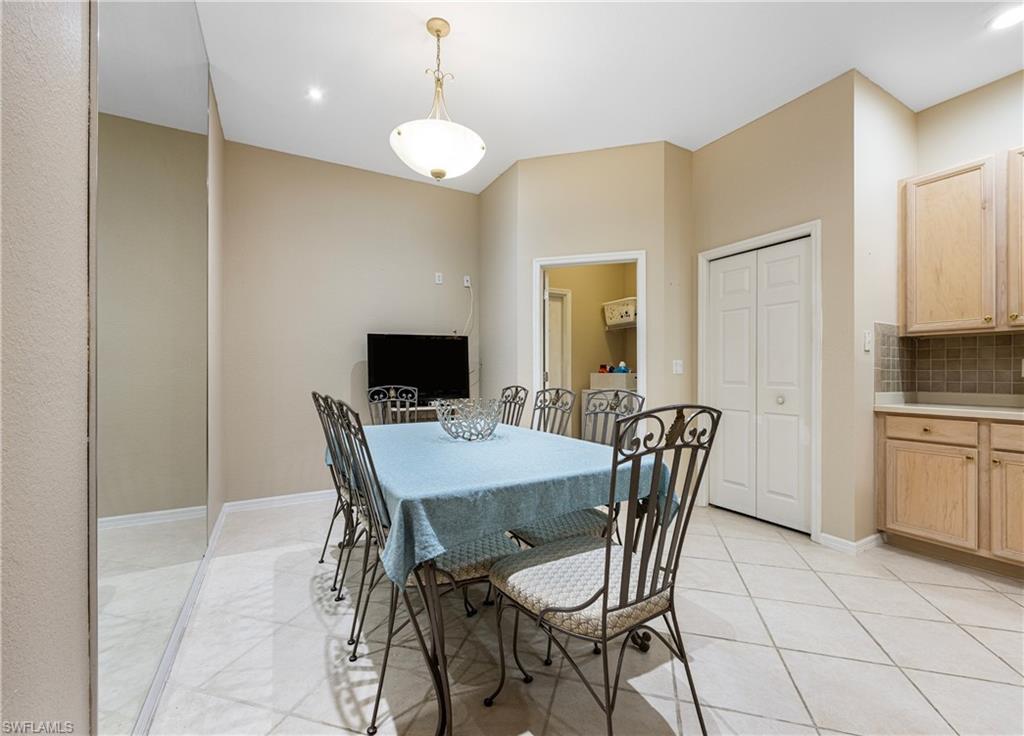 3641 Periwinkle Way Naples, FL 34114 - Photo 12 of 45 a view of a dining room with furniture