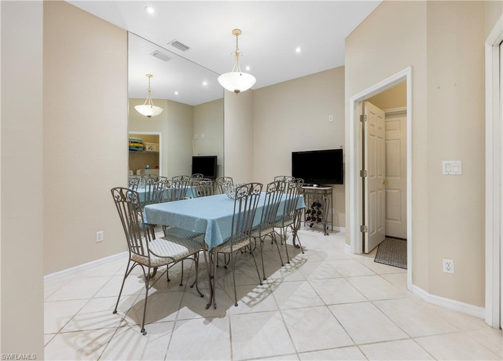 3641 Periwinkle Way Naples, FL 34114 - Photo 15 of 45 a view of a dining room with furniture and a flat screen tv