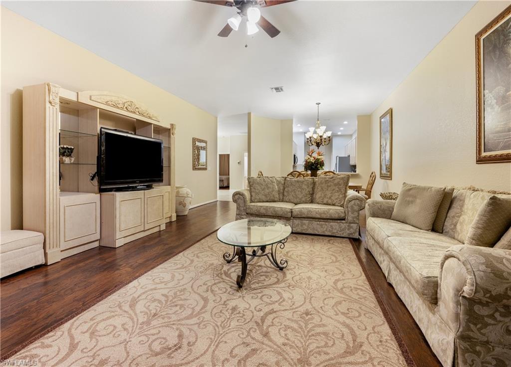 3641 Periwinkle Way Naples, FL 34114 - Photo 16 of 45 a living room with furniture and a flat screen tv