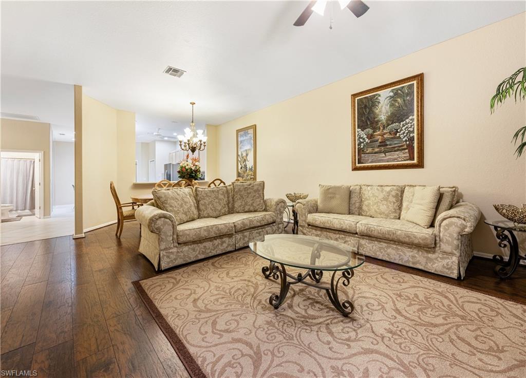 3641 Periwinkle Way Naples, FL 34114 - Photo 19 of 45 a living room with furniture and wooden floor