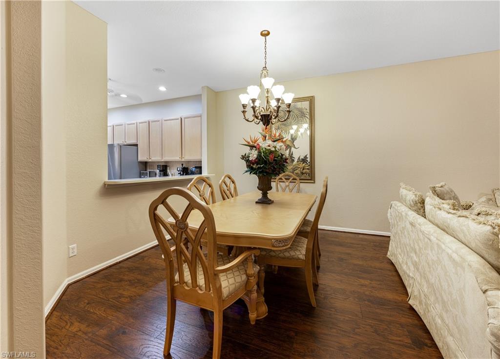 3641 Periwinkle Way Naples, FL 34114 - Photo 20 of 45 a view of a dining room with furniture and wooden floor