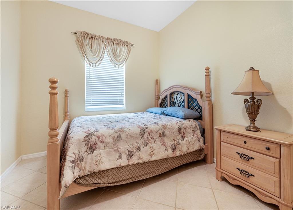 3641 Periwinkle Way Naples, FL 34114 - Photo 24 of 45 a bedroom with a bed and dresser