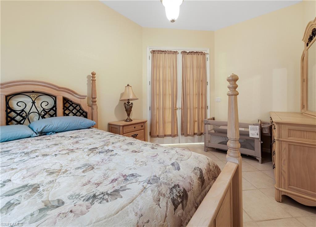 3641 Periwinkle Way Naples, FL 34114 - Photo 25 of 45 a bedroom with a bed and a couch