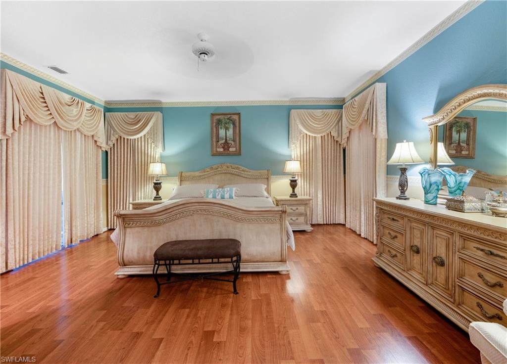 3641 Periwinkle Way Naples, FL 34114 - Photo 28 of 45 a bedroom with furniture and wooden floor