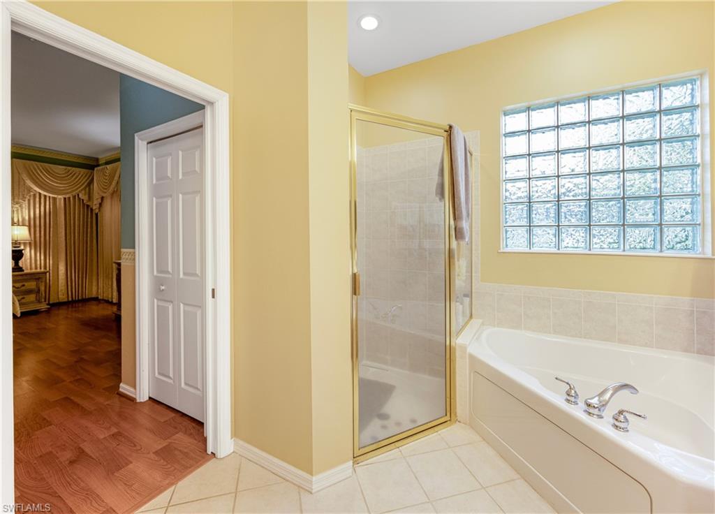 3641 Periwinkle Way Naples, FL 34114 - Photo 31 of 45 a bathroom with a bathtub and a shower