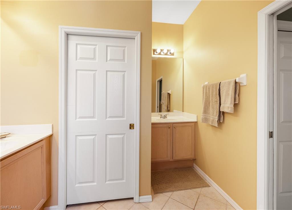 3641 Periwinkle Way Naples, FL 34114 - Photo 32 of 45 a bathroom with a sink and mirror