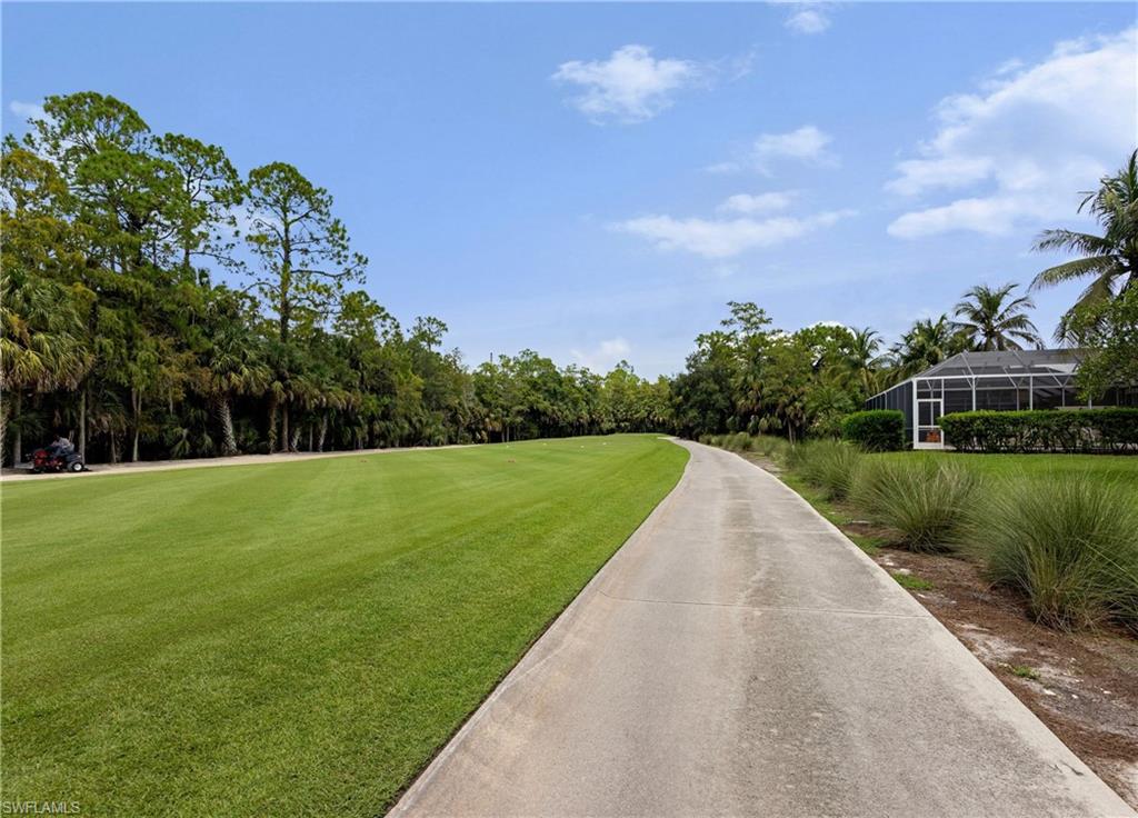 3641 Periwinkle Way Naples, FL 34114 - Photo 45 of 45 a view of a garden with a building in the background
