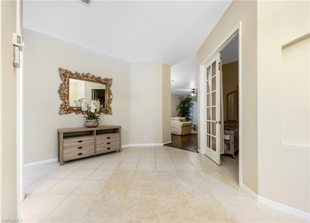 3641 Periwinkle Way Naples, FL 34114 - Photo 6 of 45 a view of a bedroom with furniture and closet