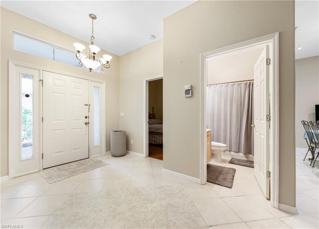 3641 Periwinkle Way Naples, FL 34114 - Photo 8 of 45 a view of a chandelier in a room with a window