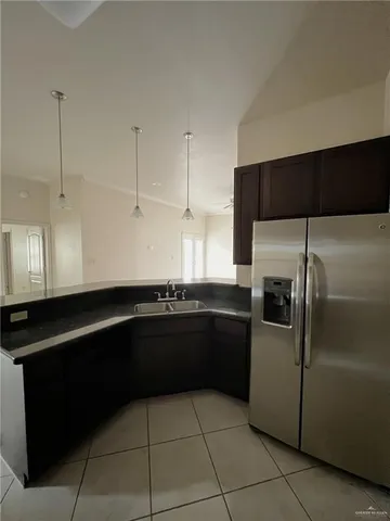 a kitchen with a refrigerator and a sink