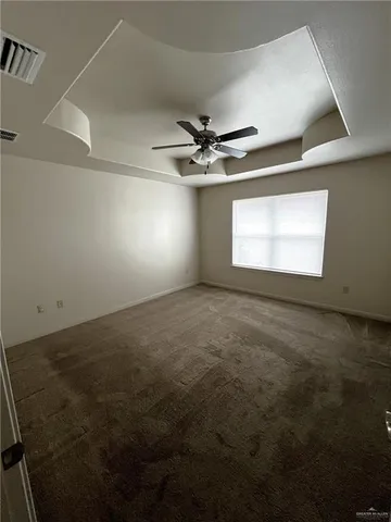 a view of a room with window and a ceiling fan