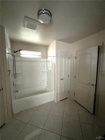 a bathroom with a shower and a glass door