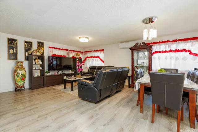 a living room with furniture a window and a flat screen tv