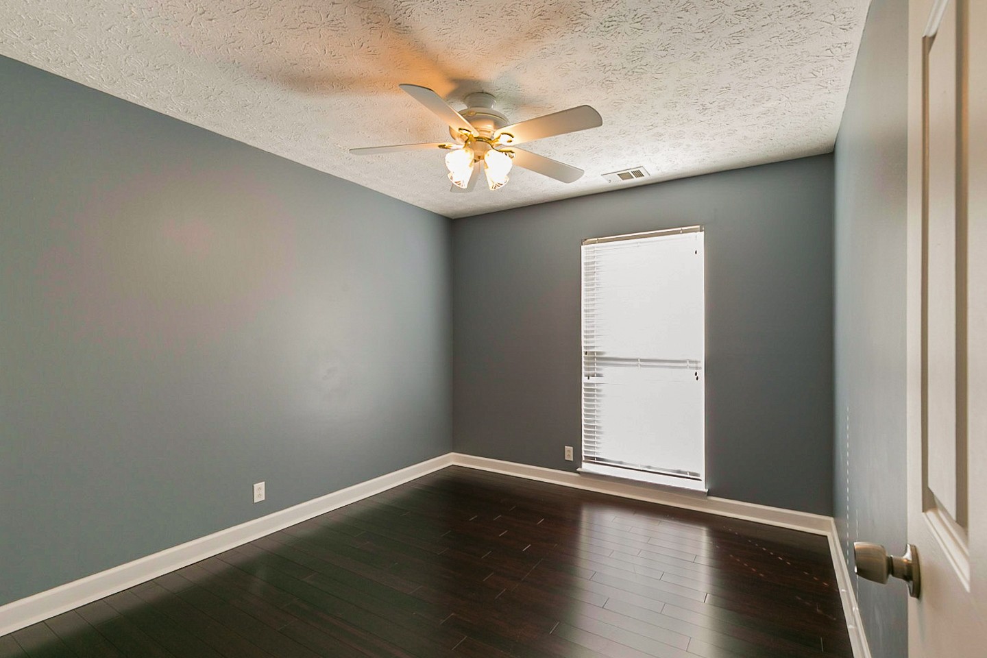 409 Ashby Place Antioch, TN 37013 - Photo 15 of 26 a view of an empty room with wooden floor and a window