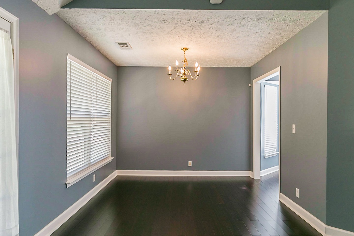 409 Ashby Place Antioch, TN 37013 - Photo 10 of 26 an empty room with wooden floor and windows