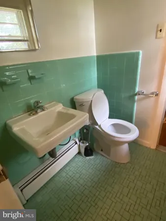 a bathroom with a sink mirror vanity and toilet