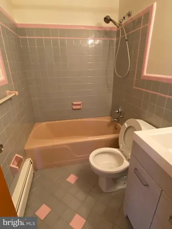 a bathroom with a toilet and a bathtub