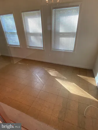 an empty room with windows and entrance