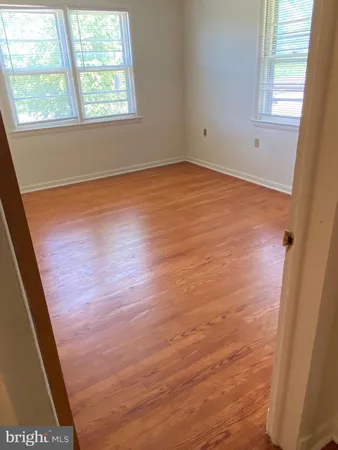 a reading room with furniture and a rug