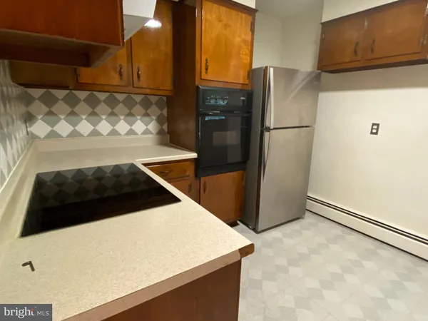 a kitchen with stainless steel appliances a refrigerator and a stove