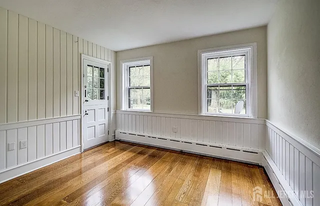 a view of a room with wooden floor and windows
