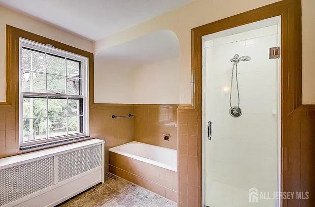 a bathroom with a tub shower and sink