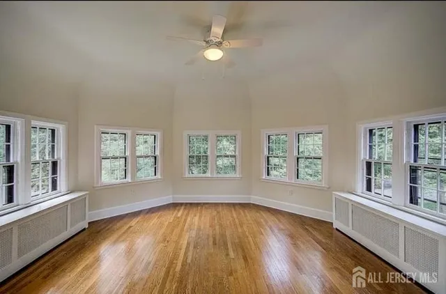 wooden floor in an empty room with a window