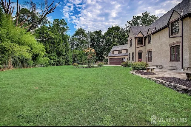 a backyard of a house with table and chairs