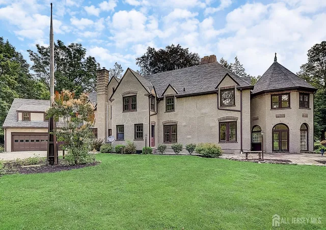 a front view of a house with a garden and plants