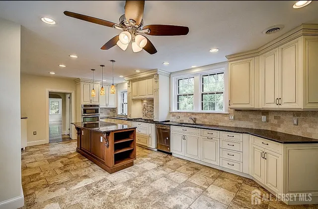a kitchen with stainless steel appliances granite countertop a stove and a sink