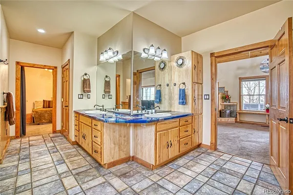 a view of a bathroom with sink shower and a mirror