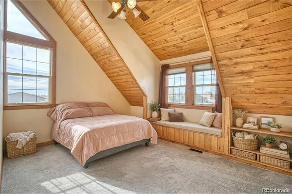 a spacious bedroom with a bed and a large window