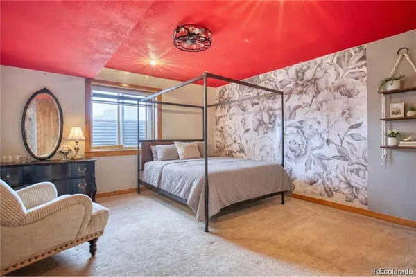 a bed room with a bed and a chair