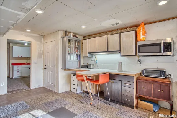 a kitchen that has a lot of cabinets in it and stainless steel appliances