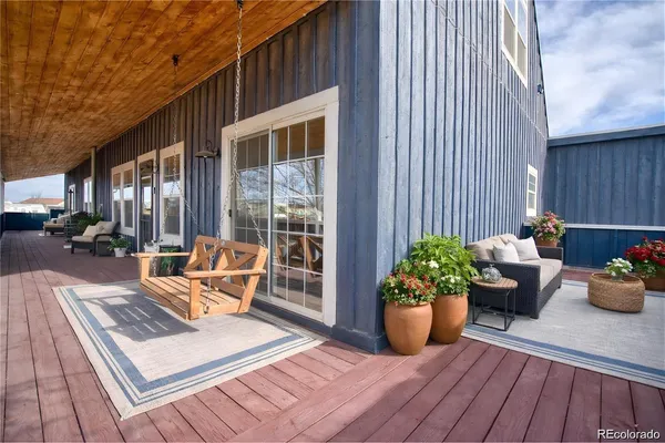 a view of a patio with couches and potted plants