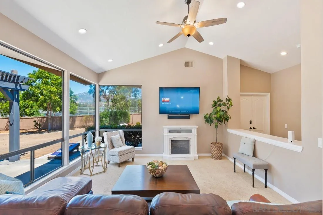 15735 Riparian Road Poway, CA 92064 - Photo 11 of 53 a living room with furniture fireplace and a flat screen tv