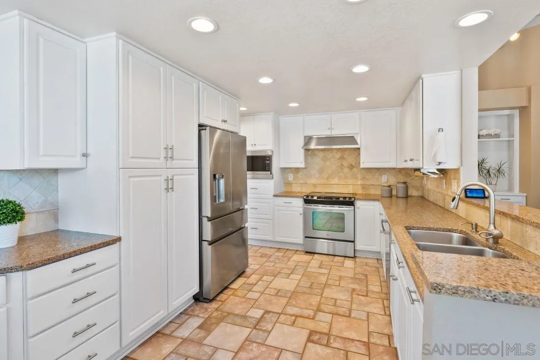 15735 Riparian Road Poway, CA 92064 - Photo 13 of 53 a kitchen with granite countertop a refrigerator and a sink